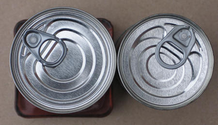 The tops of the tins, standard to the left, tall to the right