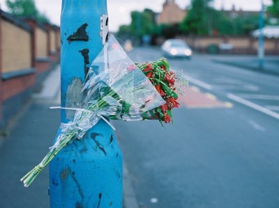 Flowers attached to lamp post in a style that has become popular since the death of Princess Diana - road accident marker