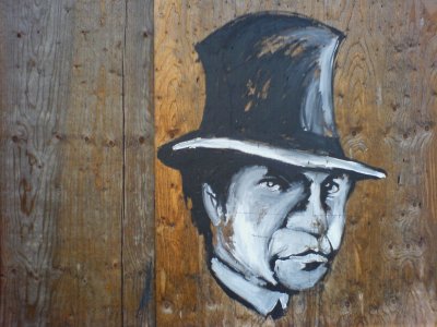 chalk drawing of a man in a top hat on a boarded up door in Wolverhampton